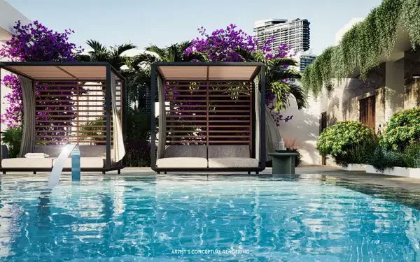 Cabañas con camas de día junto a la piscina